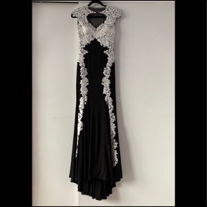 Form-fitted black dress with white lace
